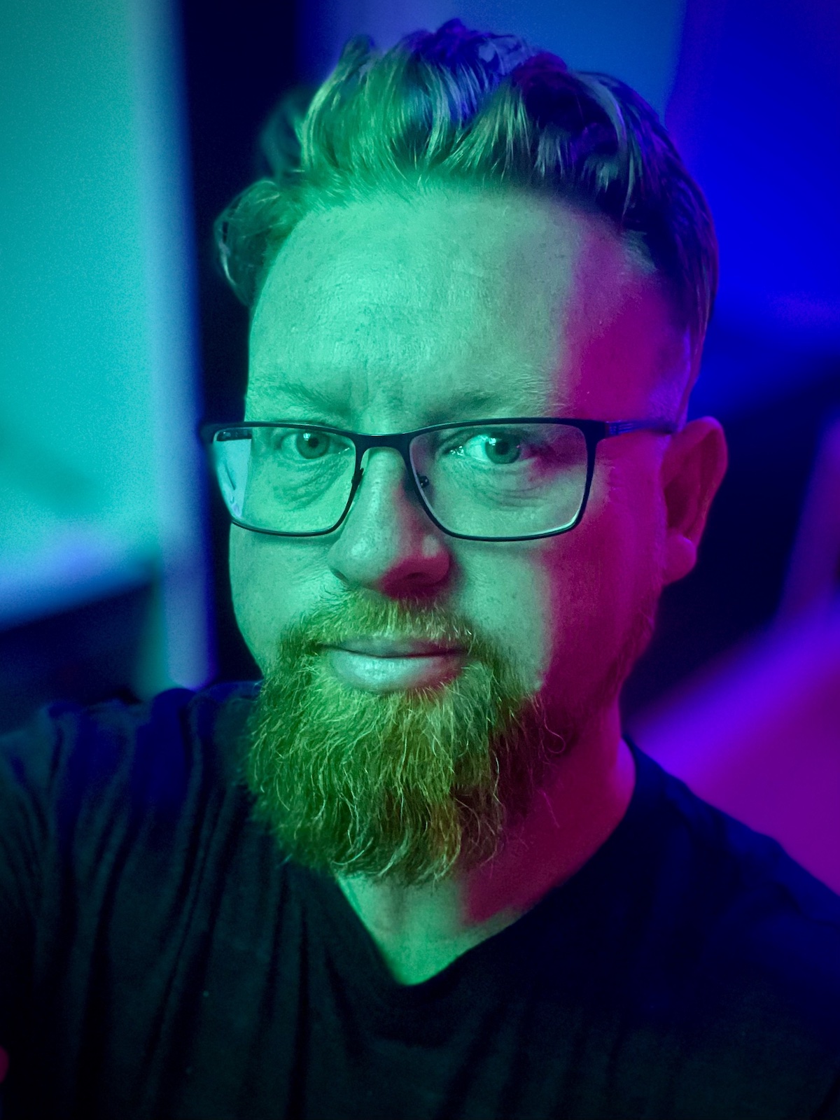 Photo of Tim Klapdor, lit using a neon colour palette