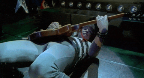 Nigel falling backwards and needing a roadie to lift him back up to keep playing.